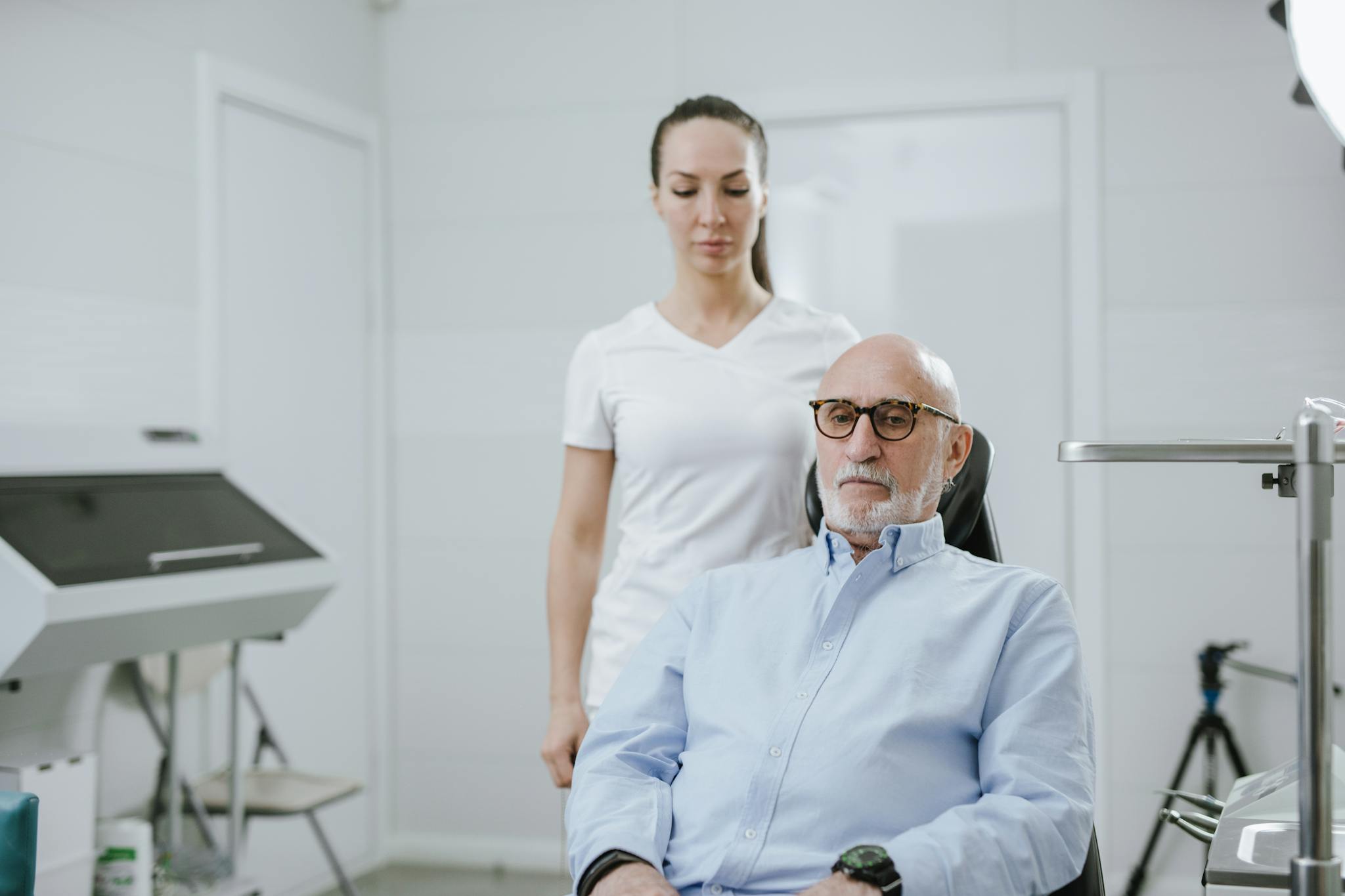 A doctor and senior patient in a modern medical clinic setting.